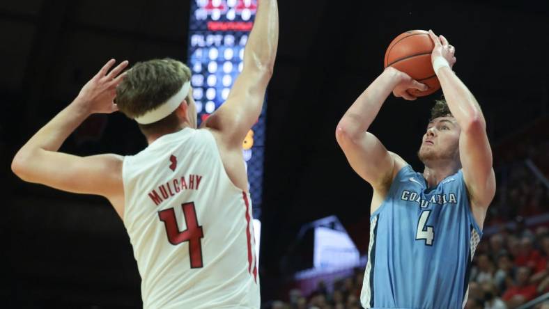 Nov 7, 2022; Piscataway, New Jersey, USA; Columbia Lions forward Liam Murphy (4) shoots the ball as Rutgers Scarlet Knights guard Paul Mulcahy (4) defends during the first half at Jersey Mike's Arena. Mandatory Credit: Vincent Carchietta-USA TODAY Sports