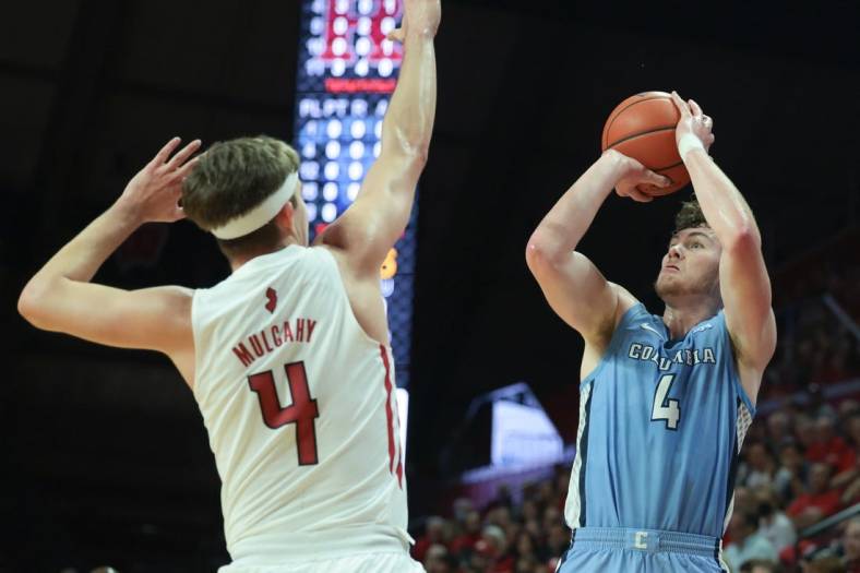 Nov 7, 2022; Piscataway, New Jersey, USA; Columbia Lions forward Liam Murphy (4) shoots the ball as Rutgers Scarlet Knights guard Paul Mulcahy (4) defends during the first half at Jersey Mike's Arena. Mandatory Credit: Vincent Carchietta-USA TODAY Sports
