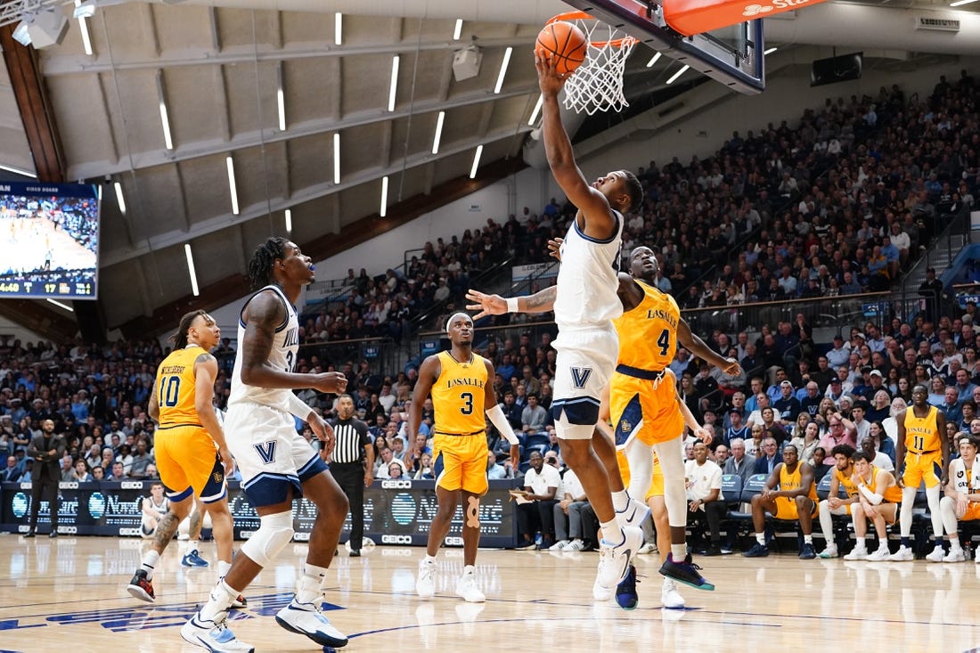 Nov 7, 2022; Villanova, Pennsylvania, USA; Villanova Wildcats forward Eric Dixon (43) shoots a reverse layup against La Salle Explorers forward Hassan Drame (4)  during the first half at William B. Finneran Pavilion. Mandatory Credit: Gregory Fisher-USA TODAY Sports