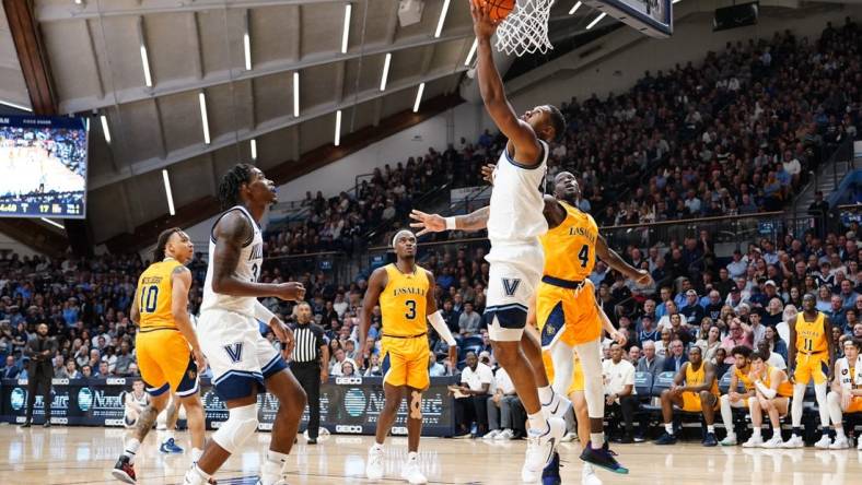 Nov 7, 2022; Villanova, Pennsylvania, USA; Villanova Wildcats forward Eric Dixon (43) shoots a reverse layup against La Salle Explorers forward Hassan Drame (4)  during the first half at William B. Finneran Pavilion. Mandatory Credit: Gregory Fisher-USA TODAY Sports