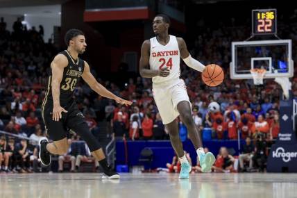 Nov 7, 2022; Dayton, Ohio, USA;  Dayton Flyers guard Kobe Elvis (24) dribbles the ball against Lindenwood Lions guard Chris Childs (30) in the second half at University of Dayton Arena. Mandatory Credit: Aaron Doster-USA TODAY Sports