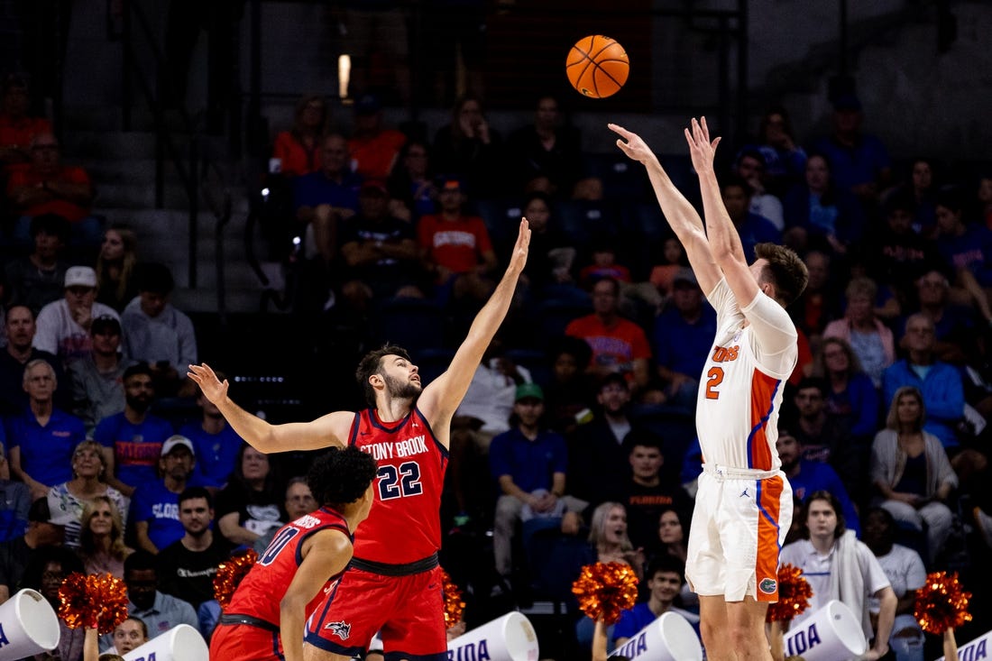 Nov 7, 2022; Gainesville, Florida, USA; Florida Gators forward Colin Castleton (12) shoots over Stony Brook Seawolves forward Kenan Sarvan (22) during the first half at Exactech Arena at the Stephen C. O'Connell Center. Mandatory Credit: Matt Pendleton-USA TODAY Sports