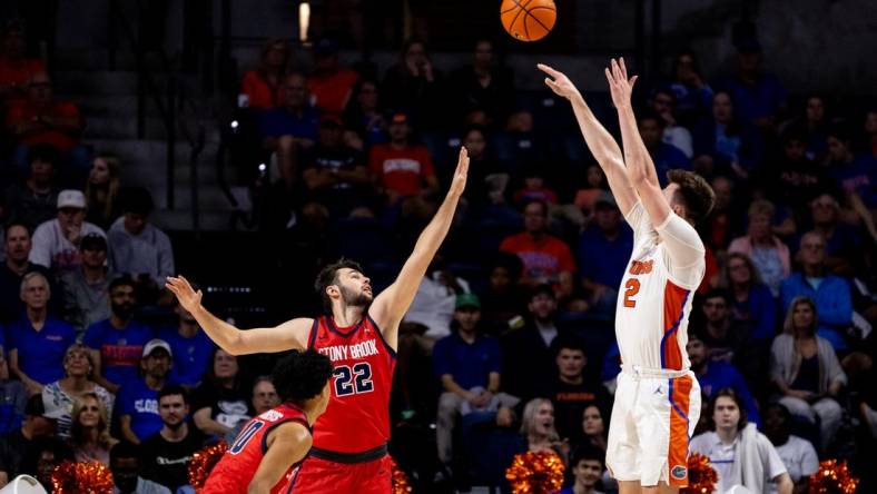 Nov 7, 2022; Gainesville, Florida, USA; Florida Gators forward Colin Castleton (12) shoots over Stony Brook Seawolves forward Kenan Sarvan (22) during the first half at Exactech Arena at the Stephen C. O'Connell Center. Mandatory Credit: Matt Pendleton-USA TODAY Sports