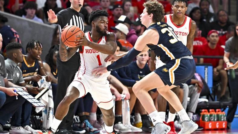 Nov 7, 2022; Houston, Texas, USA; Houston Cougars guard Jamal Shead (1) looks to pass the ball as Northern Colorado Bears guard Caleb Shaw (30) defends during the first half at Fertitta Center. Mandatory Credit: Maria Lysaker-USA TODAY Sports