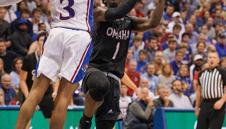 Nov 7, 2022; Lawrence, Kansas, USA; Omaha Mavericks  guard JJ White (1)  shoots as Kansas Jayhawk guard Dajuan Harris Jr. (3) defends during the first half at Allen Fieldhouse. Mandatory Credit: Denny Medley-USA TODAY Sports