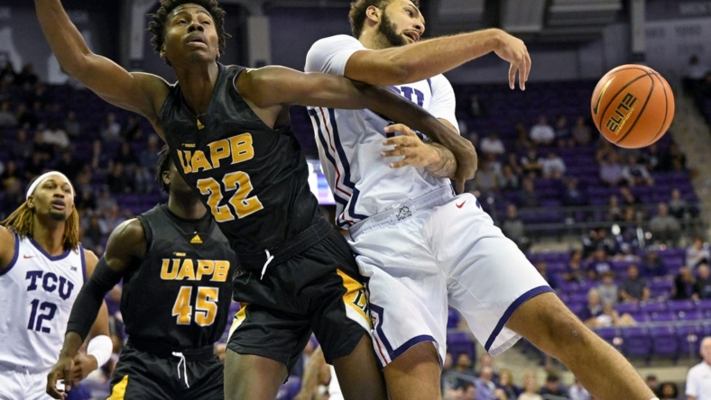 Nov 7, 2022; Fort Worth, Texas, USA; TCU Horned Frogs forward JaKobe Coles (21) knocks the ball away from Arkansas-Pine Bluff Golden Lions forward Robert Lewis (22) during the first half at Ed and Rae Schollmaier Arena. Mandatory Credit: Jerome Miron-USA TODAY Sports