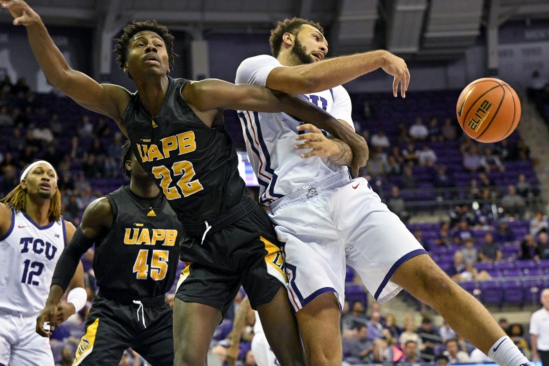 Nov 7, 2022; Fort Worth, Texas, USA; TCU Horned Frogs forward JaKobe Coles (21) knocks the ball away from Arkansas-Pine Bluff Golden Lions forward Robert Lewis (22) during the first half at Ed and Rae Schollmaier Arena. Mandatory Credit: Jerome Miron-USA TODAY Sports