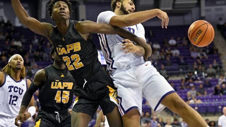 Nov 7, 2022; Fort Worth, Texas, USA; TCU Horned Frogs forward JaKobe Coles (21) knocks the ball away from Arkansas-Pine Bluff Golden Lions forward Robert Lewis (22) during the first half at Ed and Rae Schollmaier Arena. Mandatory Credit: Jerome Miron-USA TODAY Sports