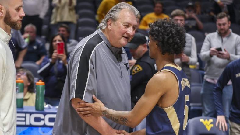 Nov 7, 2022; Morgantown, West Virginia, USA; West Virginia Mountaineers head coach Bob Huggins talks with Mount St. Mary's Mountaineers guard Jalen Benjamin (5) after the game at WVU Coliseum. Mandatory Credit: Ben Queen-USA TODAY Sports