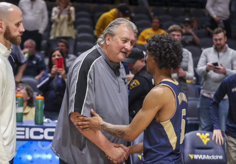 Nov 7, 2022; Morgantown, West Virginia, USA; West Virginia Mountaineers head coach Bob Huggins talks with Mount St. Mary's Mountaineers guard Jalen Benjamin (5) after the game at WVU Coliseum. Mandatory Credit: Ben Queen-USA TODAY Sports