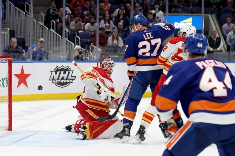 Nov 7, 2022; Elmont, New York, USA; Calgary Flames goaltender Jacob Markstrom (25) allows the game winning goal to New York Islanders defenseman Noah Dobson (not pictured) during overtime at UBS Arena. Mandatory Credit: Brad Penner-USA TODAY Sports