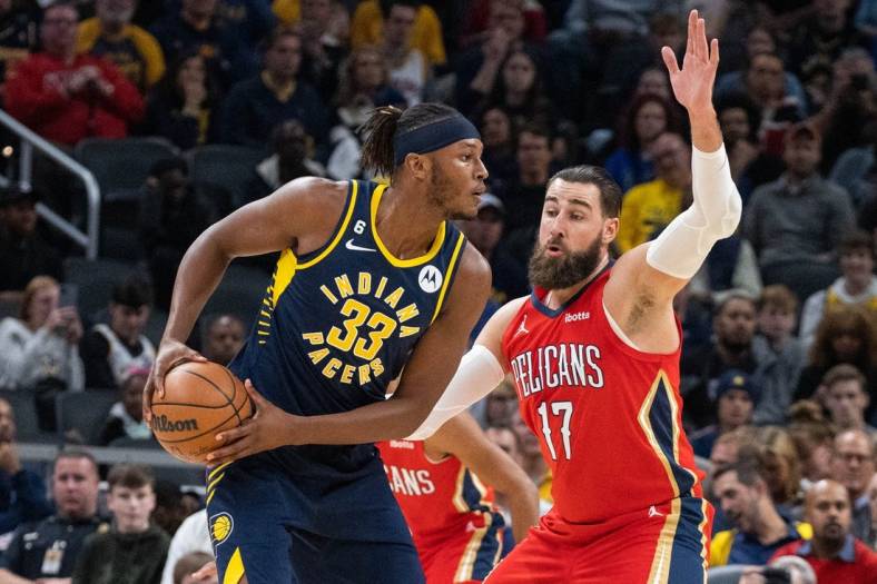 Nov 7, 2022; Indianapolis, Indiana, USA;  Indiana Pacers center Myles Turner (33) looks to pass the ball while New Orleans Pelicans center Jonas Valanciunas (17) defends in the second quarter at Gainbridge Fieldhouse. Mandatory Credit: Trevor Ruszkowski-USA TODAY Sports