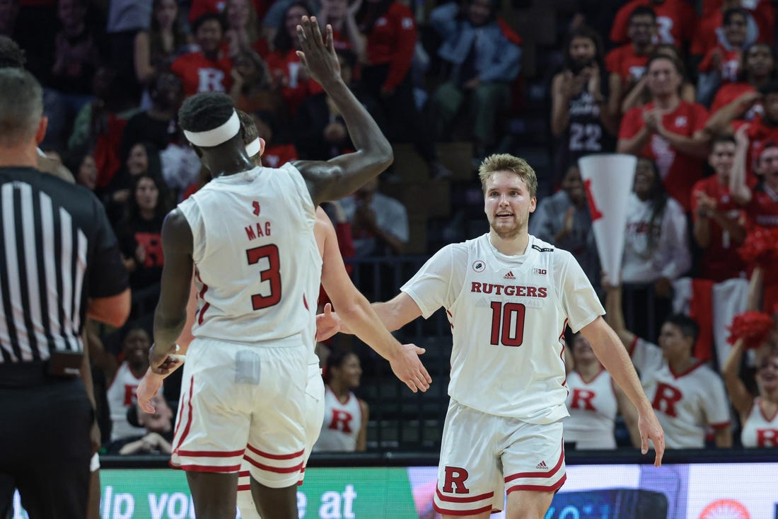 Nov 7, 2022; Piscataway, New Jersey, USA; Rutgers Scarlet Knights guard Cam Spencer (10) is congratulated by teammates after a basket against the Columbia Lions during the second half at Jersey Mike's Arena. Mandatory Credit: Vincent Carchietta-USA TODAY Sports