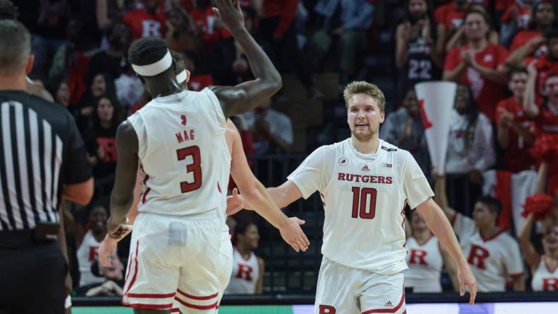 Nov 7, 2022; Piscataway, New Jersey, USA; Rutgers Scarlet Knights guard Cam Spencer (10) is congratulated by teammates after a basket against the Columbia Lions during the second half at Jersey Mike's Arena. Mandatory Credit: Vincent Carchietta-USA TODAY Sports