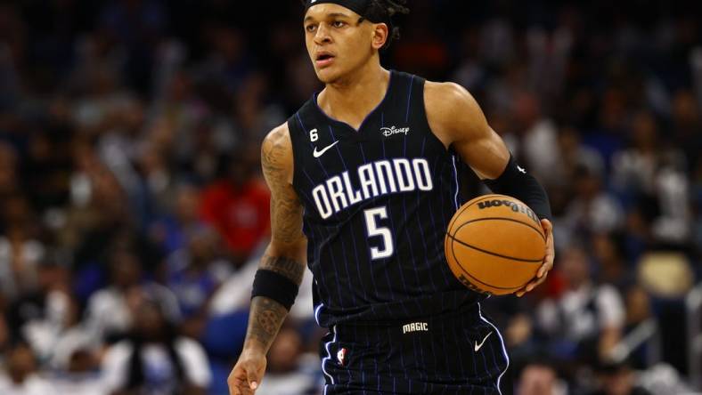 Nov 7, 2022; Orlando, Florida, USA; Orlando Magic forward Paolo Banchero (5) drives to the basket against the Houston Rockets during the second half at Amway Center. Mandatory Credit: Kim Klement-USA TODAY Sports