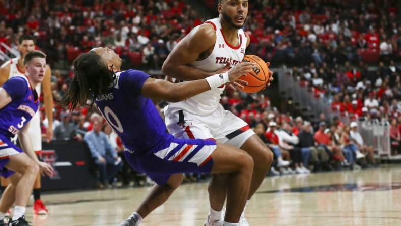 Nov 7, 2022; Lubbock, Texas, USA;  Texas Tech Red Raiders forward Kevin Obanor (0) collides with Northwestern State Demons guard Greedy Williams (10) in the first half at United Supermarkets Arena. Mandatory Credit: Michael C. Johnson-USA TODAY Sports