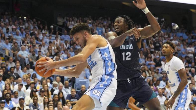 Nov 7, 2022; Chapel Hill, North Carolina, USA;  North Carolina Tar Heels forward Pete Nance (32) gets the rebound against North Carolina-Wilmington Seahawks center Victor Enoh (12) during the first half at Dean E. Smith Center. Mandatory Credit: James Guillory-USA TODAY Sports