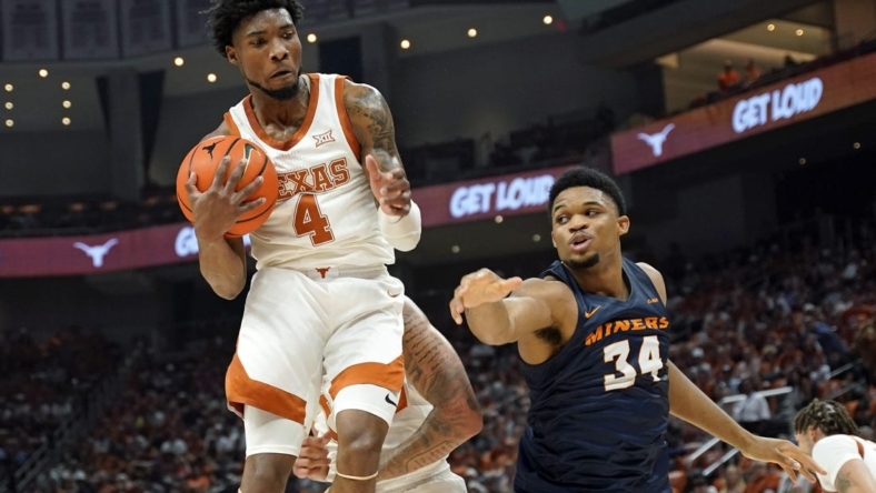 Nov 7, 2022; Austin, Texas, USA; Texas Longhorns forward guard Tyrese Hunter (4) grabs a rebound away from Texas-El Paso Miners forward Kevin Kalu (34) during the first half at Moody Center. Mandatory Credit: Scott Wachter-USA TODAY Sports