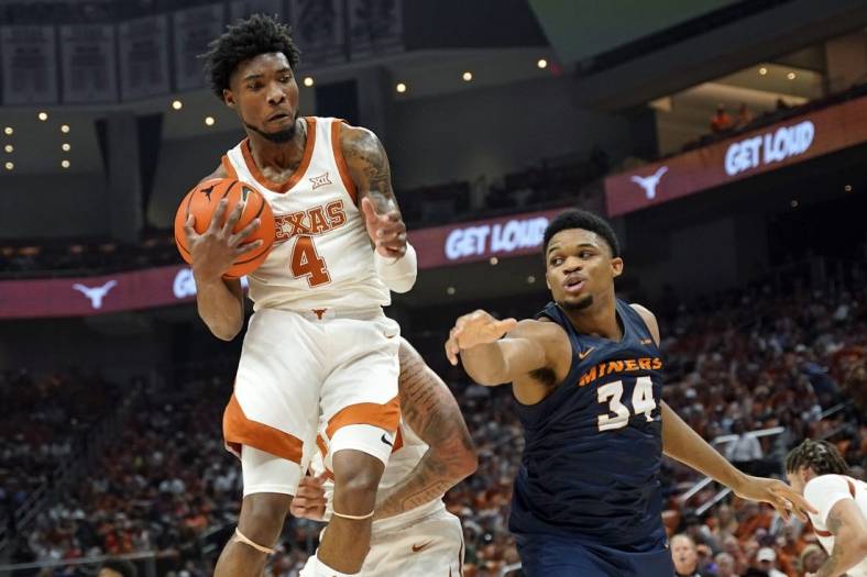 Nov 7, 2022; Austin, Texas, USA; Texas Longhorns forward guard Tyrese Hunter (4) grabs a rebound away from Texas-El Paso Miners forward Kevin Kalu (34) during the first half at Moody Center. Mandatory Credit: Scott Wachter-USA TODAY Sports