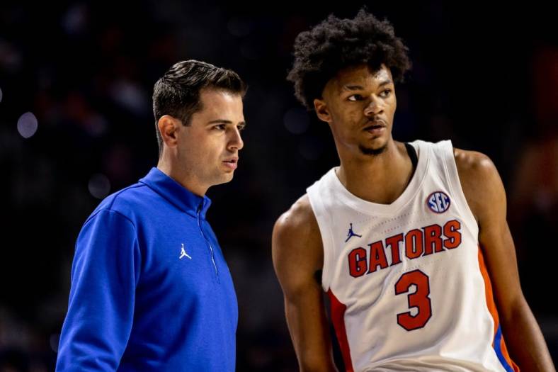 Nov 7, 2022; Gainesville, Florida, USA; Florida Gators head coach Todd Golden talks with Florida Gators forward Alex Fudge (3) in a timeout during the second half against the Stony Brook Seawolves at Exactech Arena at the Stephen C. O'Connell Center. Mandatory Credit: Matt Pendleton-USA TODAY Sports