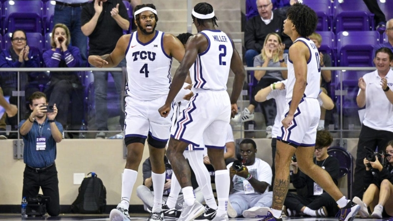 Nov 7, 2022; Fort Worth, Texas, USA; TCU Horned Frogs center Eddie Lampkin Jr. (4) and forward Emanuel Miller (2) celebrate during the second half against the Arkansas-Pine Bluff Golden Lions at Ed and Rae Schollmaier Arena. Mandatory Credit: Jerome Miron-USA TODAY Sports