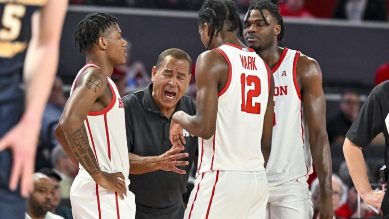 Nov 7, 2022; Houston, Texas, USA; Houston Cougars head coach Kelvin Sampson speaks with guard Tramon Mark (12), guard Marcus Sasser (0) and forward Jarace Walker (25) during the second half against the Northern Colorado Bears at Fertitta Center. Mandatory Credit: Maria Lysaker-USA TODAY Sports