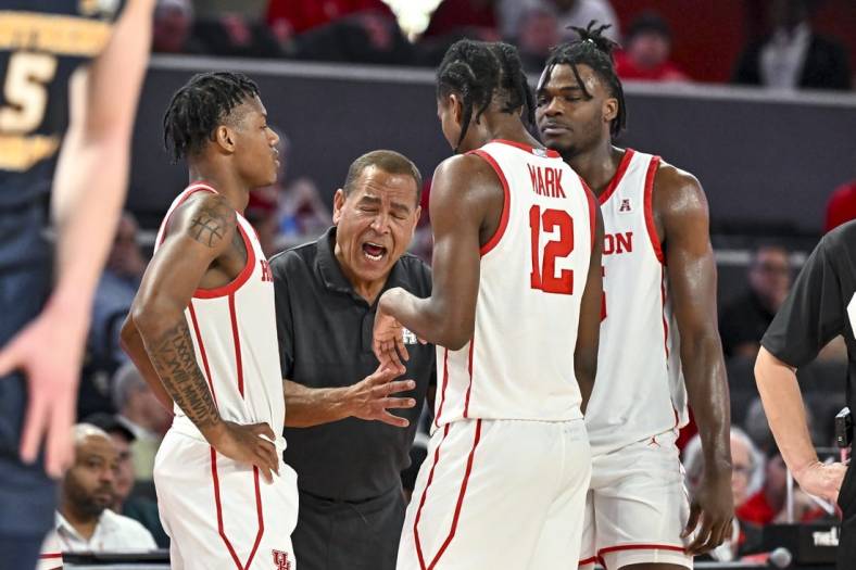 Nov 7, 2022; Houston, Texas, USA; Houston Cougars head coach Kelvin Sampson speaks with guard Tramon Mark (12), guard Marcus Sasser (0) and forward Jarace Walker (25) during the second half against the Northern Colorado Bears at Fertitta Center. Mandatory Credit: Maria Lysaker-USA TODAY Sports