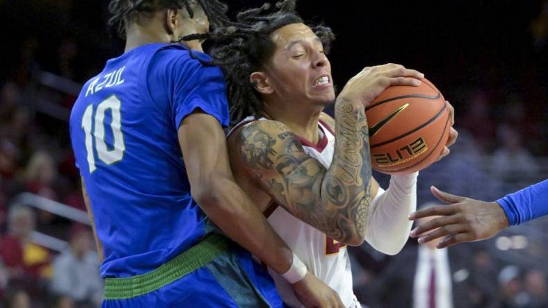 Nov 7, 2022; Los Angeles, California, USA;  USC Trojans guard Tre White (22) is defended by Florida Gulf Coast Eagles forward Zach Anderson (10) as he drives to the basket in the first half at Galen Center. Mandatory Credit: Jayne Kamin-Oncea-USA TODAY Sports