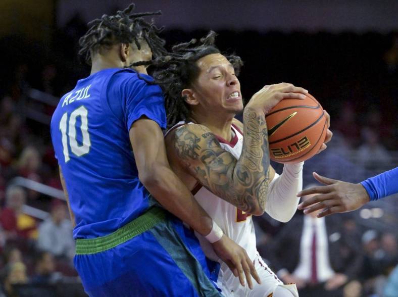 Nov 7, 2022; Los Angeles, California, USA;  USC Trojans guard Tre White (22) is defended by Florida Gulf Coast Eagles forward Zach Anderson (10) as he drives to the basket in the first half at Galen Center. Mandatory Credit: Jayne Kamin-Oncea-USA TODAY Sports