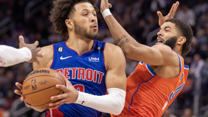 Nov 7, 2022; Detroit, Michigan, USA; Detroit Pistons guard Cade Cunningham (2) drives to the basket on Oklahoma City Thunder forward Kenrich Williams (34) during the in the second half at Little Caesars Arena. Mandatory Credit: David Reginek-USA TODAY Sports