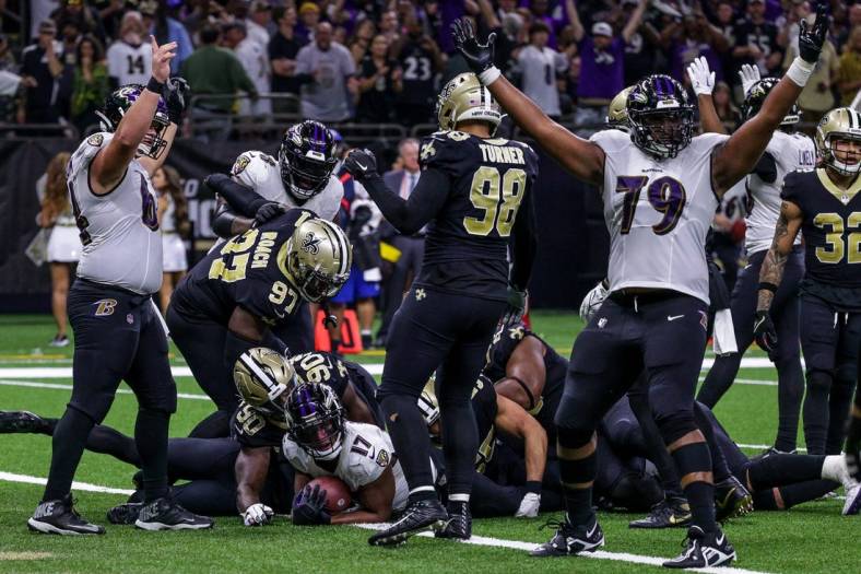 Nov 7, 2022; New Orleans, Louisiana, USA; New Orleans Saints defensive end Tanoh Kpassagnon (90) tackles Baltimore Ravens running back Kenyan Drake (17) in the end zone as he makes a touchdown during the second half at Caesars Superdome. Mandatory Credit: Stephen Lew-USA TODAY Sports