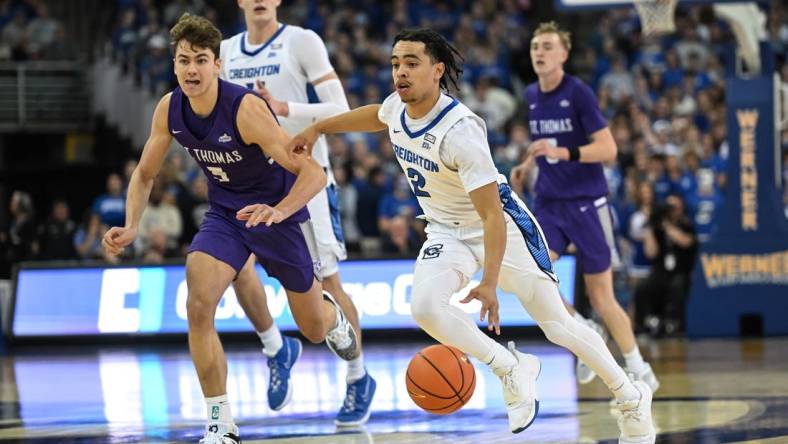 Nov 7, 2022; Omaha, Nebraska, USA;  Creighton Bluejays guard Ryan Nembhard (2) drives up the court against St. Thomas - Minnesota Tommies forward Parker Bjorklund (5)during the second half at CHI Health Center Omaha. Mandatory Credit: Steven Branscombe-USA TODAY Sports