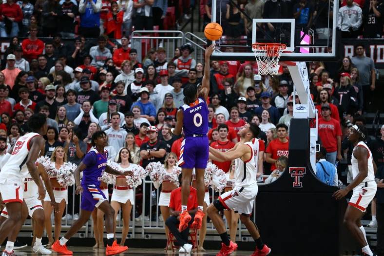 Nov 7, 2022; Lubbock, Texas, USA;  Northwestern State Demons guard Demarcus Sharp (0) shoots over Texas Tech Red Raiders forward Daniel Batcho (12) in the second half at United Supermarkets Arena. Mandatory Credit: Michael C. Johnson-USA TODAY Sports
