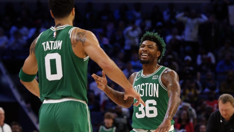 Nov 7, 2022; Memphis, Tennessee, USA; Boston Celtics guard Marcus Smart (36) reacts with forward Jayson Tatum (0) after a dunk during the second half against the Memphis Grizzlies at FedExForum. Mandatory Credit: Petre Thomas-USA TODAY Sports