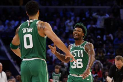 Boston Celtics guard Marcus Smart (36) reacts with forward Jayson Tatum (0) after a dunk during the second half against the Memphis Grizzlies at FedExForum. Mandatory Credit: Petre Thomas-USA TODAY Sports