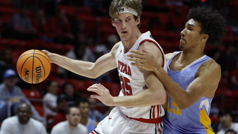 Nov 7, 2022; Salt Lake City, Utah, USA;  Utah Utes center Branden Carlson (35) drives against LIU Sharks forward C.J. Delancy (15) in the first half at Jon M. Huntsman Center. Mandatory Credit: Jeffrey Swinger-USA TODAY Sports