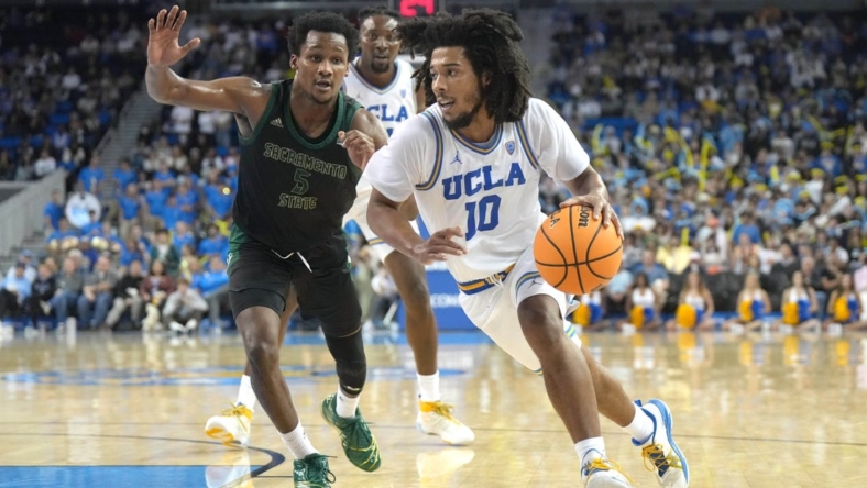 Nov 7, 2022; Los Angeles, California, USA; UCLA Bruins guard Tyger Campbell (10) dribbles the ball against Sacramento State Hornets guard Gianni Hunt (5) in the second half at Pauley Pavilion. Mandatory Credit: Kirby Lee-USA TODAY Sports