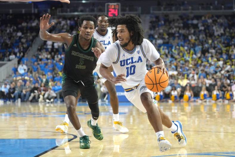Nov 7, 2022; Los Angeles, California, USA; UCLA Bruins guard Tyger Campbell (10) dribbles the ball against Sacramento State Hornets guard Gianni Hunt (5) in the second half at Pauley Pavilion. Mandatory Credit: Kirby Lee-USA TODAY Sports