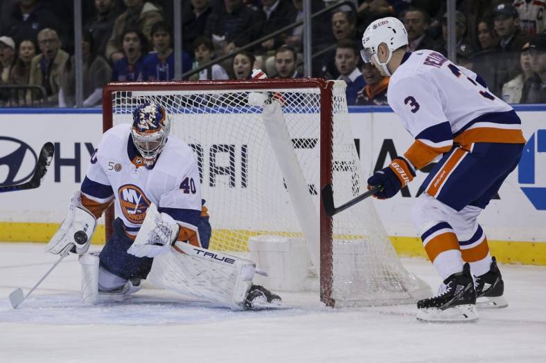 Nov 8, 2022; New York, New York, USA; New York Islanders goaltender Semyon Varlamov (40) makes a save against a shot by a New York Rangers player as New York Islanders defenseman Adam Pelech (3) watches during the first period of a game at Madison Square Garden. Mandatory Credit: Jessica Alcheh-USA TODAY Sports