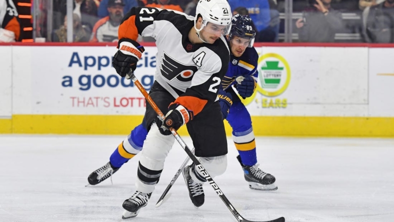 Nov 8, 2022; Philadelphia, Pennsylvania, USA;  Philadelphia Flyers center Scott Laughton (21) carries the puck against St. Louis Blues left wing Pavel Buchnevich (89) during the second period at Wells Fargo Center. Mandatory Credit: Eric Hartline-USA TODAY Sports
