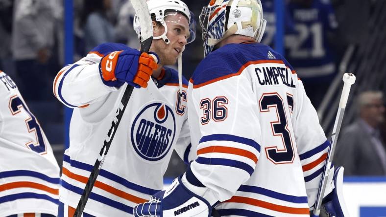 Nov 8, 2022; Tampa, Florida, USA; Edmonton Oilers goaltender Jack Campbell (36) is congratulated by center Connor McDavid (97) after they defeated the Tampa Bay Lightning at Amalie Arena. Mandatory Credit: Kim Klement-USA TODAY Sports