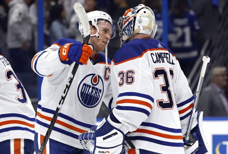 Nov 8, 2022; Tampa, Florida, USA; Edmonton Oilers goaltender Jack Campbell (36) is congratulated by center Connor McDavid (97) after they defeated the Tampa Bay Lightning at Amalie Arena. Mandatory Credit: Kim Klement-USA TODAY Sports