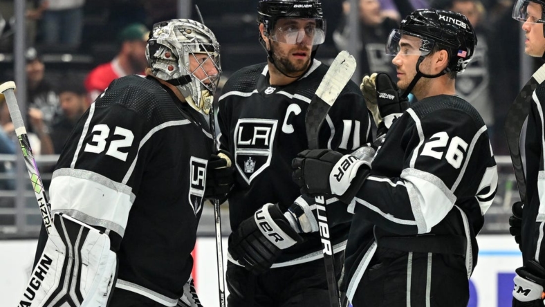 Nov 8, 2022; Los Angeles, California, USA; Los Angeles Kings goaltender Jonathan Quick (32) is congratulated by center Anze Kopitar (11) and defenseman Sean Walker (26) after defeating the Minnesota Wild at Crypto.com Arena. Mandatory Credit: Jayne Kamin-Oncea-USA TODAY Sports