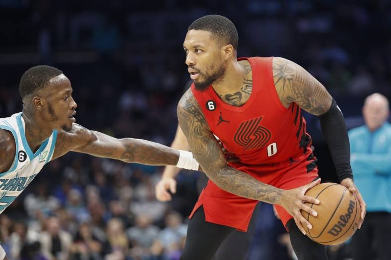 Nov 9, 2022; Charlotte, North Carolina, USA; Portland Trail Blazers guard Damian Lillard (0) looks to drive against Charlotte Hornets guard Terry Rozier (3) during the second quarter at Spectrum Center. Mandatory Credit: Nell Redmond-USA TODAY Sports