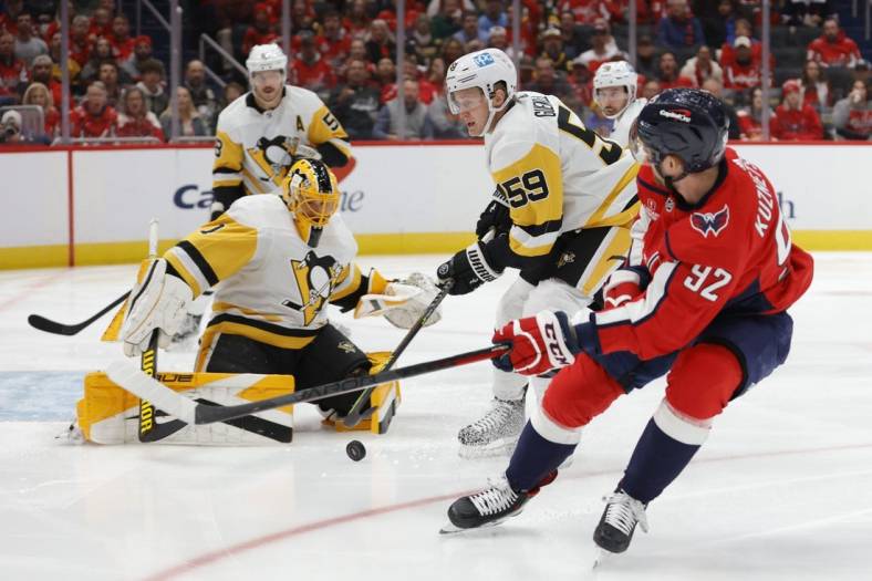 Nov 9, 2022; Washington, District of Columbia, USA; Pittsburgh Penguins goaltender Casey DeSmith (1) makes a save on Washington Capitals center Evgeny Kuznetsov (92) as Penguins left wing Jake Guentzel (59) defends in the first period at Capital One Arena. Mandatory Credit: Geoff Burke-USA TODAY Sports