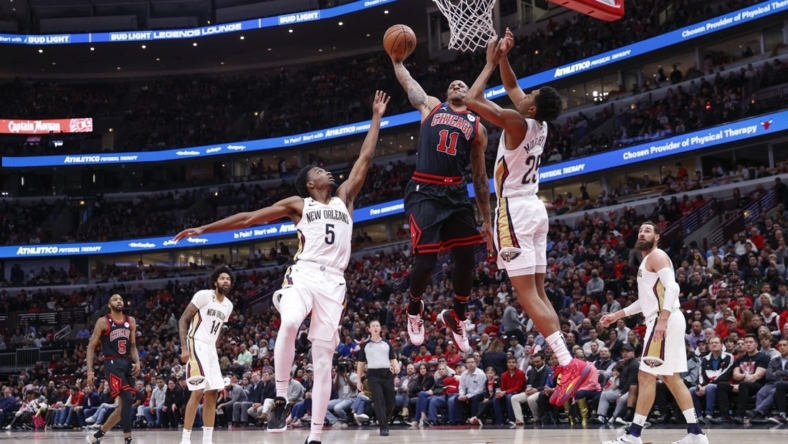 Nov 9, 2022; Chicago, Illinois, USA; Chicago Bulls forward DeMar DeRozan (11) goes up for a dunk against the New Orleans Pelicans during the first half at United Center. Mandatory Credit: Kamil Krzaczynski-USA TODAY Sports