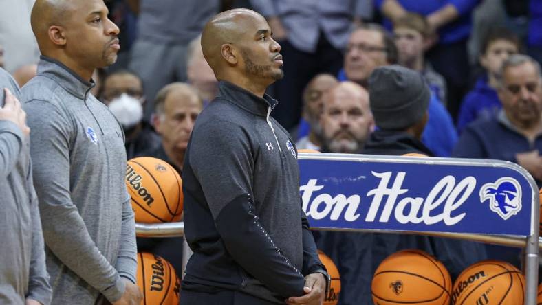 Nov 9, 2022; Newark, New Jersey, USA; Seton Hall Pirates head coach Shaheen Holloway (right) stands during the national anthem before the game against the Monmouth Hawks at Prudential Center. Mandatory Credit: Vincent Carchietta-USA TODAY Sports