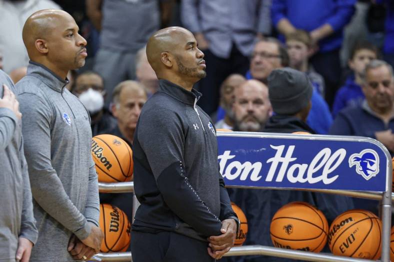 Nov 9, 2022; Newark, New Jersey, USA; Seton Hall Pirates head coach Shaheen Holloway (right) stands during the national anthem before the game against the Monmouth Hawks at Prudential Center. Mandatory Credit: Vincent Carchietta-USA TODAY Sports