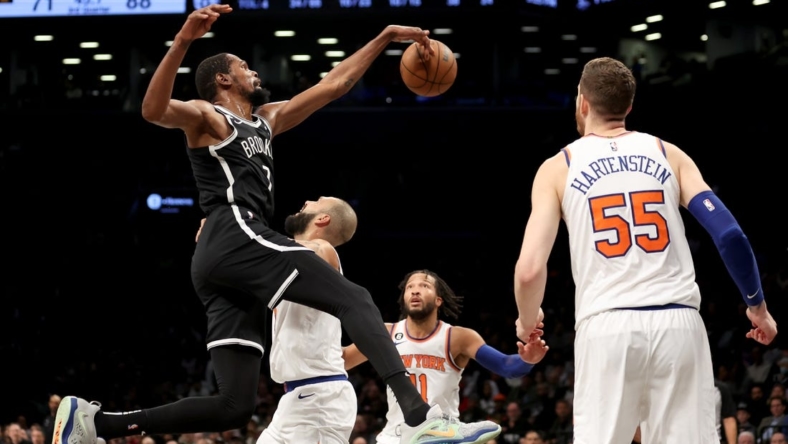 Nov 9, 2022; Brooklyn, New York, USA; Brooklyn Nets forward Kevin Durant (7) fights for the ball against New York Knicks guard Evan Fournier (13) and guard Jalen Brunson (11) and center Isaiah Hartenstein (55) during the third quarter at Barclays Center. Mandatory Credit: Brad Penner-USA TODAY Sports
