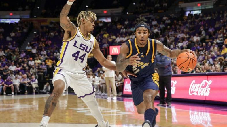 Nov 9, 2022; Baton Rouge, Louisiana, USA; UMKC Kangaroos guard RayQuawndis Mitchell (21) dribbles against LSU Tigers guard Adam Miller (44) during the second half at Pete Maravich Assembly Center. Mandatory Credit: Stephen Lew-USA TODAY Sports